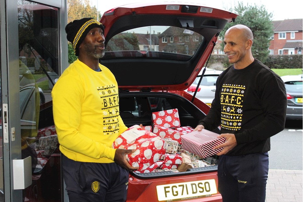 Burton Albion manager Jimmy Floyd Hasselbaink and assistant manager Dino Maamria donate toys and presents to the Derek