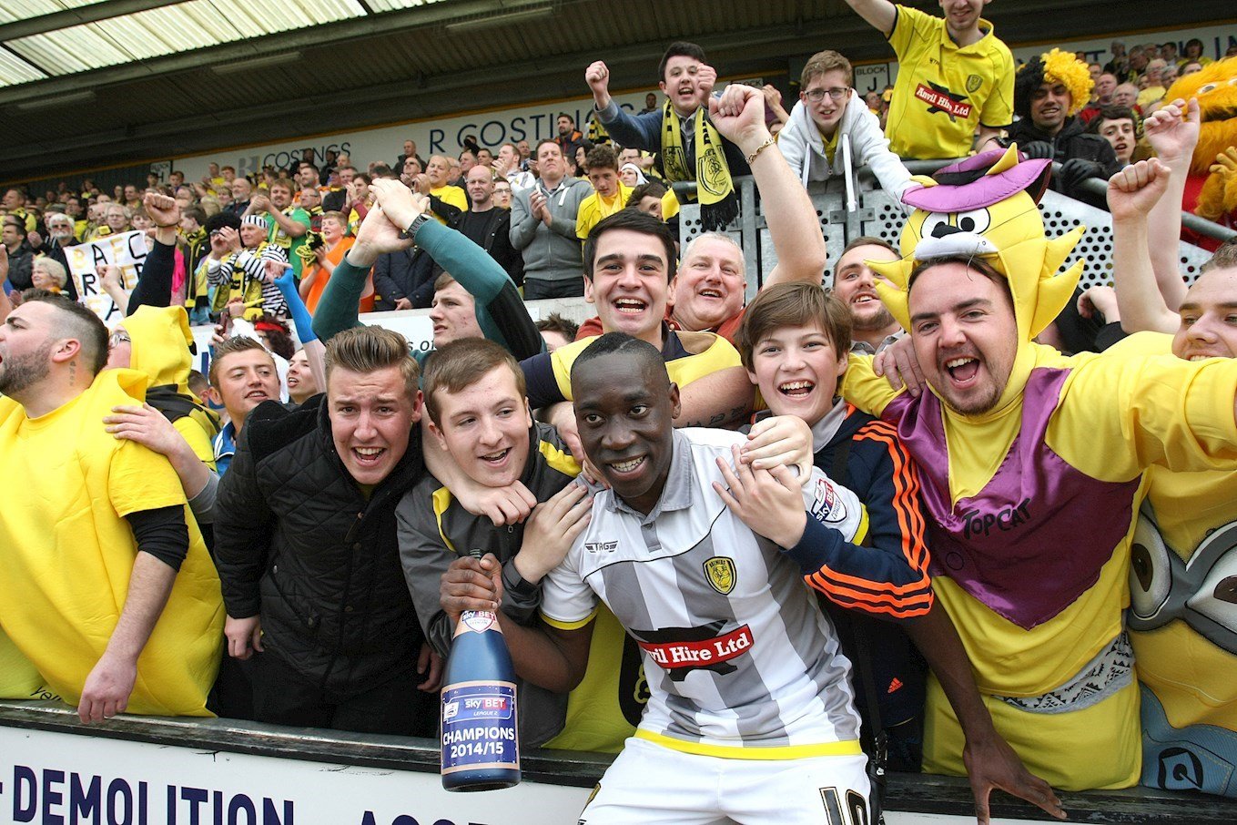 Lucas Akins celebrates winning the Sky Bet League Two title at Cambridge United in May 2015