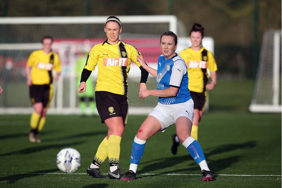 Emily Gillott passes the ball forward in Burton Albion